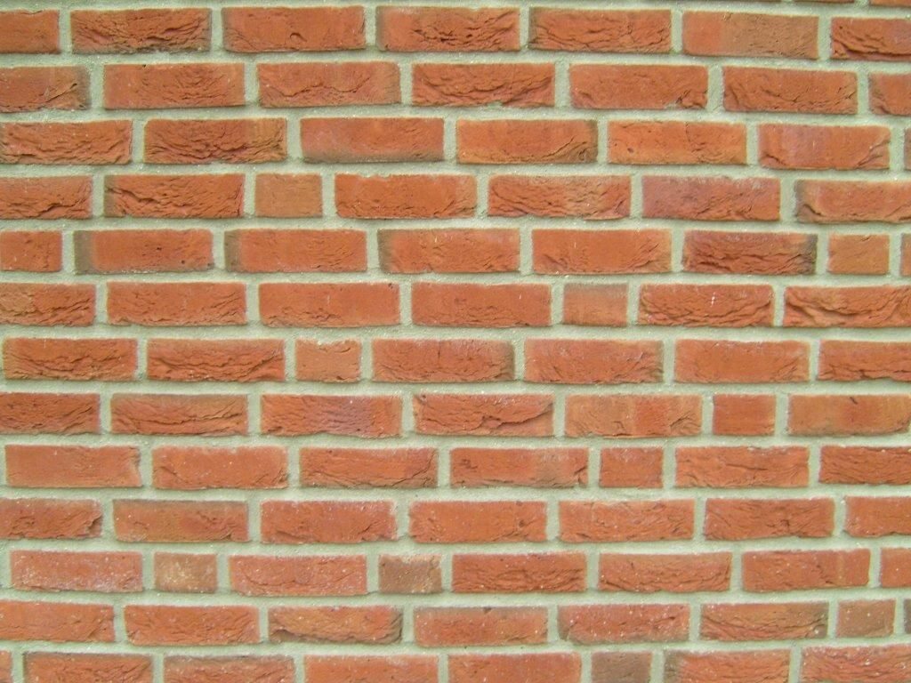 Close view of red brick wall and mortar joints